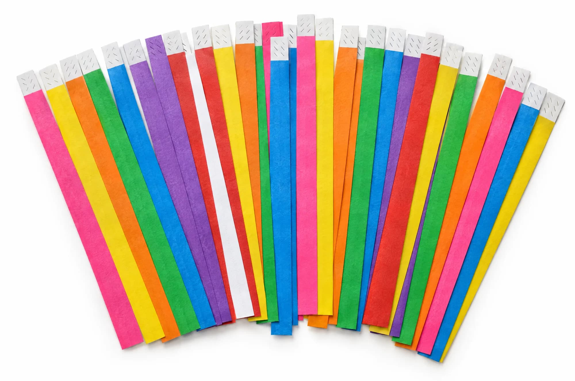 Paper wristbands in pink, yellow, orange, green, blue, violet, red and white, fanned out on a white surface